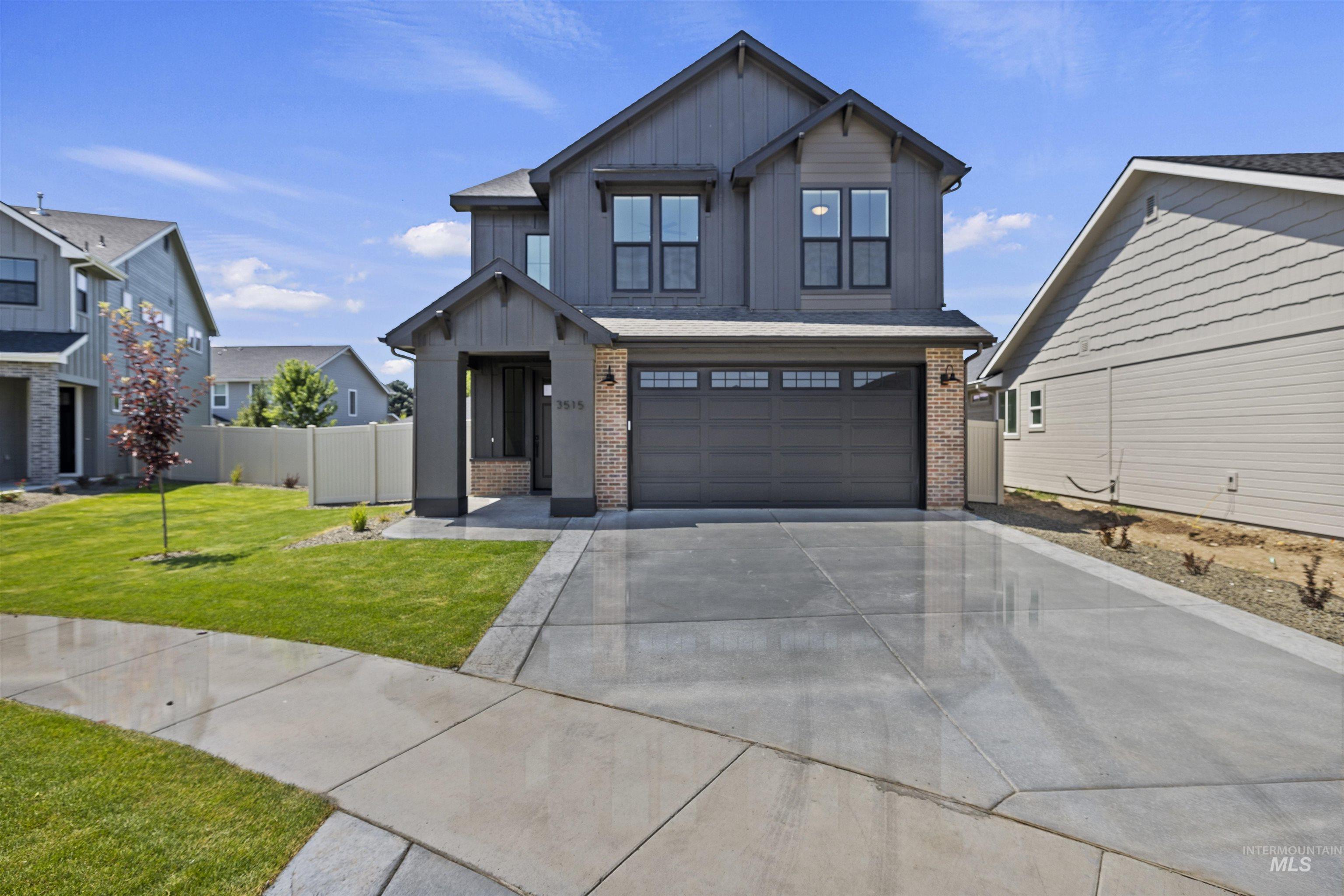 3515 South El Rio Avenue Boise, ID 83709 - Photo 2 of 47 View of front of house with brick siding, board and batten siding, concrete driveway, and an attached garage
