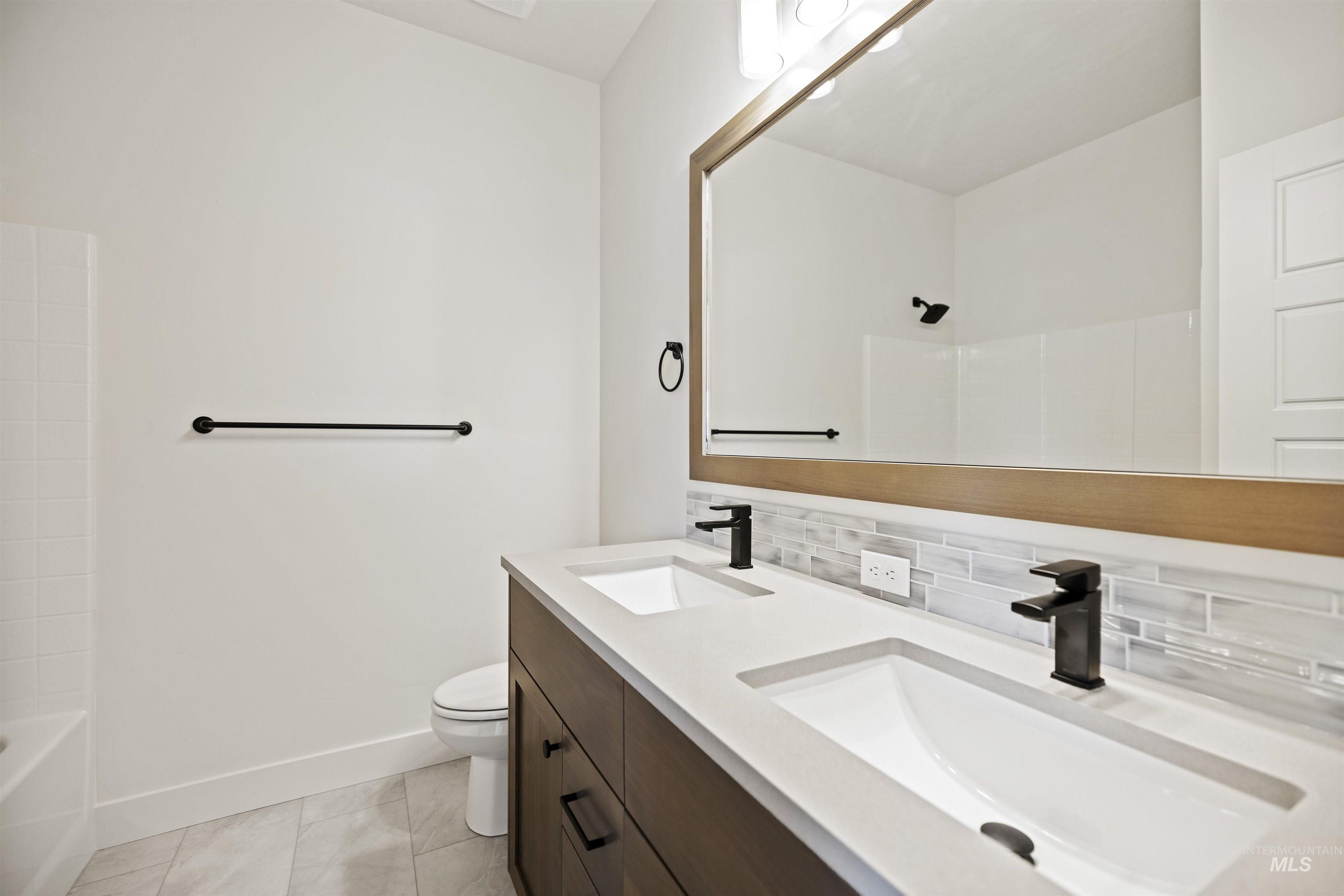 3515 South El Rio Avenue Boise, ID 83709 - Photo 32 of 47 Bathroom featuring double vanity, decorative backsplash, and tub / shower combination