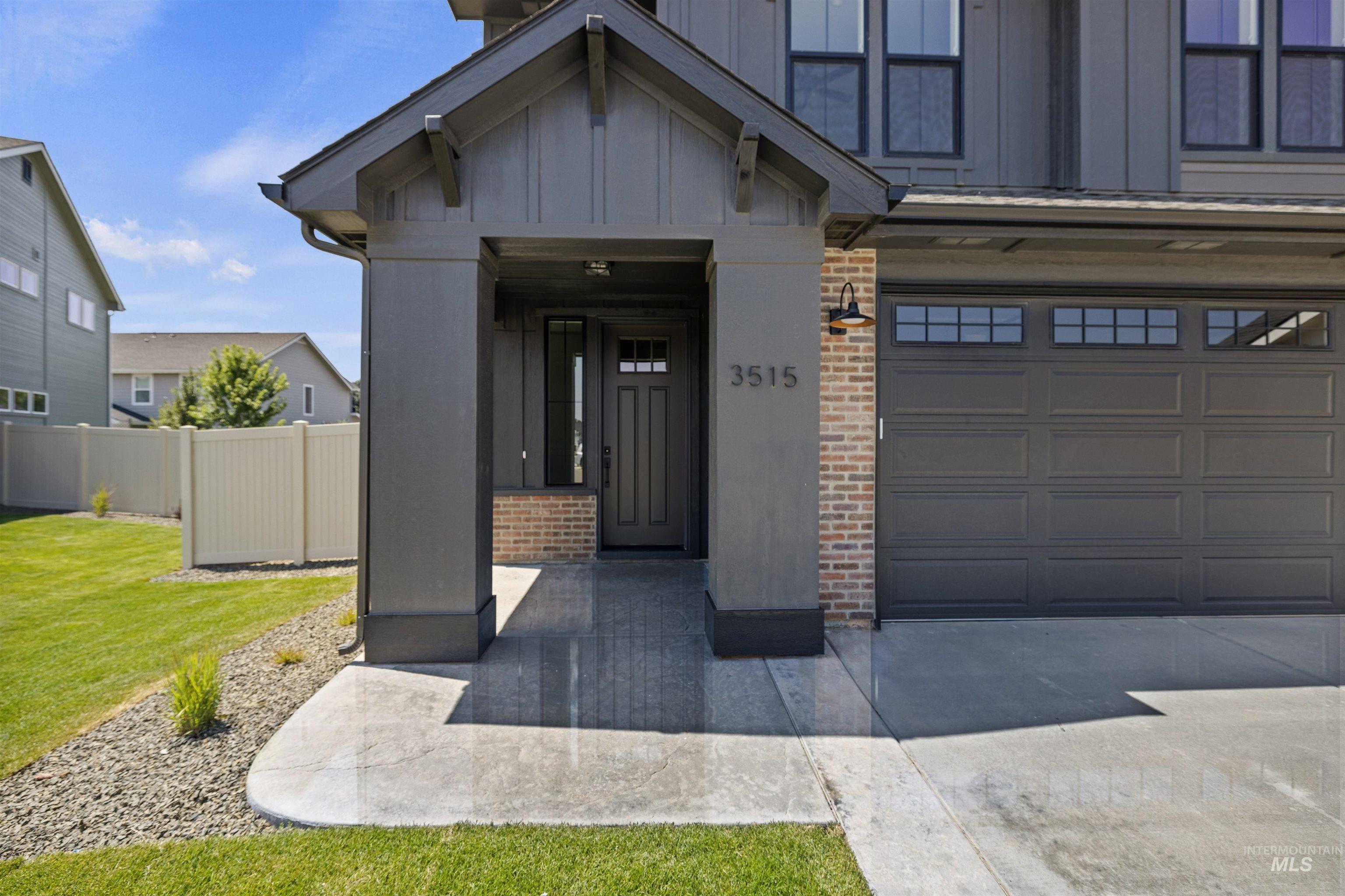 3515 South El Rio Avenue Boise, ID 83709 - Photo 4 of 47 Entrance to property featuring brick siding, board and batten siding, driveway, and an attached garage