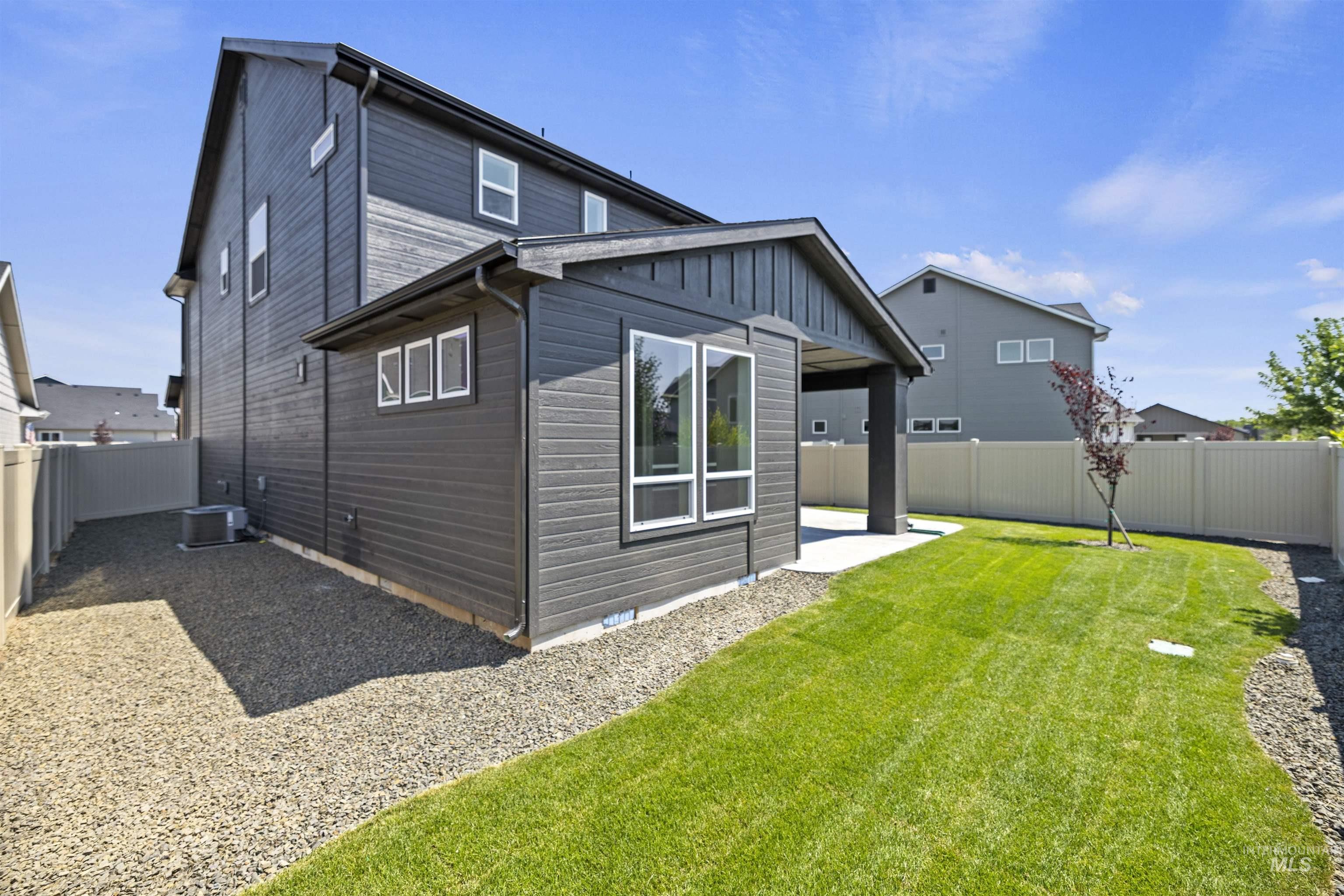 3515 South El Rio Avenue Boise, ID 83709 - Photo 45 of 47 Rear view of house featuring a fenced backyard, a patio area, and board and batten siding