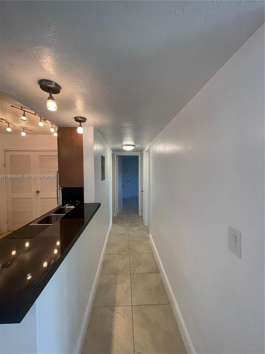 7483 Southwest 82nd Street, Unit A101 Miami, FL 33143 - Photo 19 of 39 a lobby with a couch and a mirror