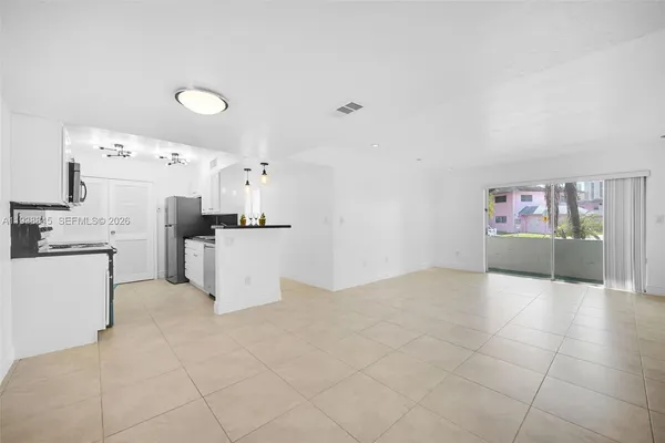 a kitchen with cabinets and stainless steel appliances