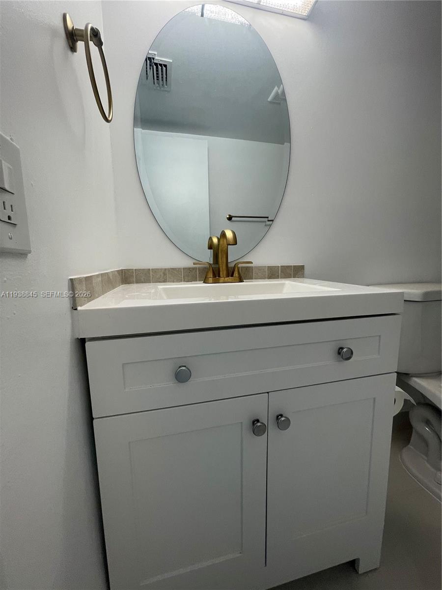 7483 Southwest 82nd Street, Unit A101 Miami, FL 33143 - Photo 22 of 39 a close view of light fixtures and a mirror