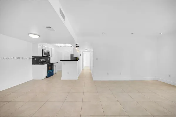 a kitchen with stainless steel appliances a sink stove and refrigerator