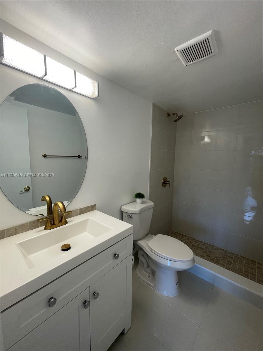 7483 Southwest 82nd Street, Unit A101 Miami, FL 33143 - Photo 24 of 39 a bathroom with a sink and a mirror