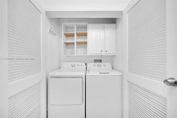a kitchen with stainless steel appliances granite countertop white cabinets and a granite counter tops