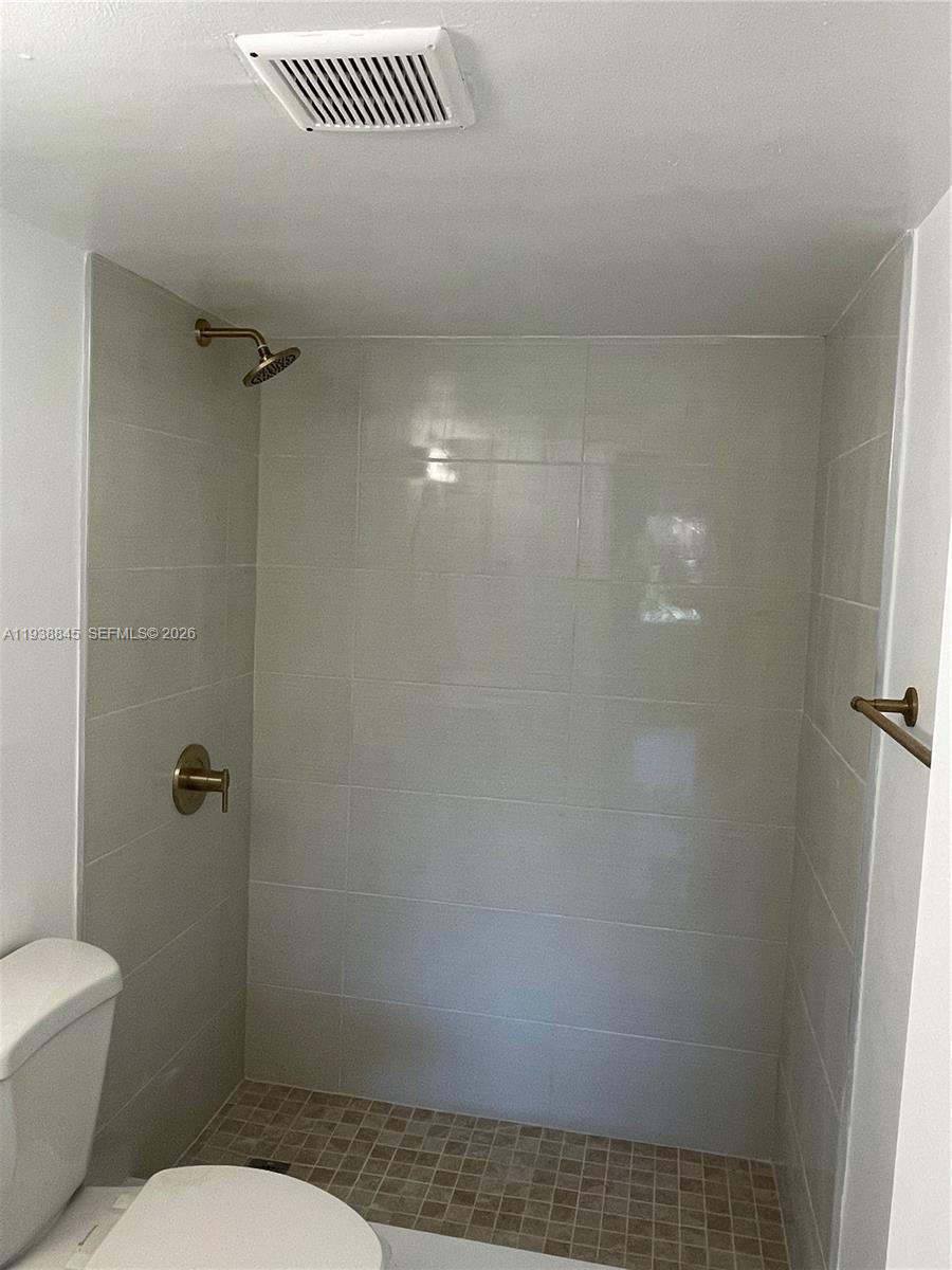 7483 Southwest 82nd Street, Unit A101 Miami, FL 33143 - Photo 27 of 39 a bathroom with a toilet and a shower