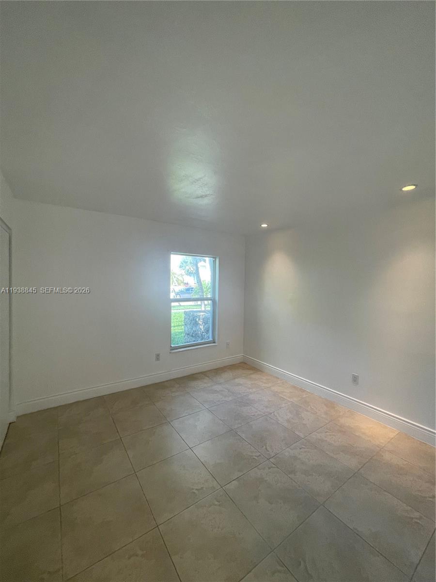 7483 Southwest 82nd Street, Unit A101 Miami, FL 33143 - Photo 33 of 39 an empty room with a empty space and windows