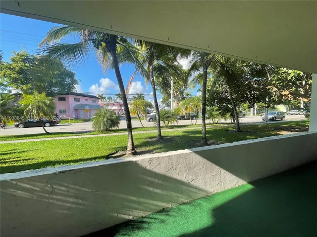 a view of a park with large trees