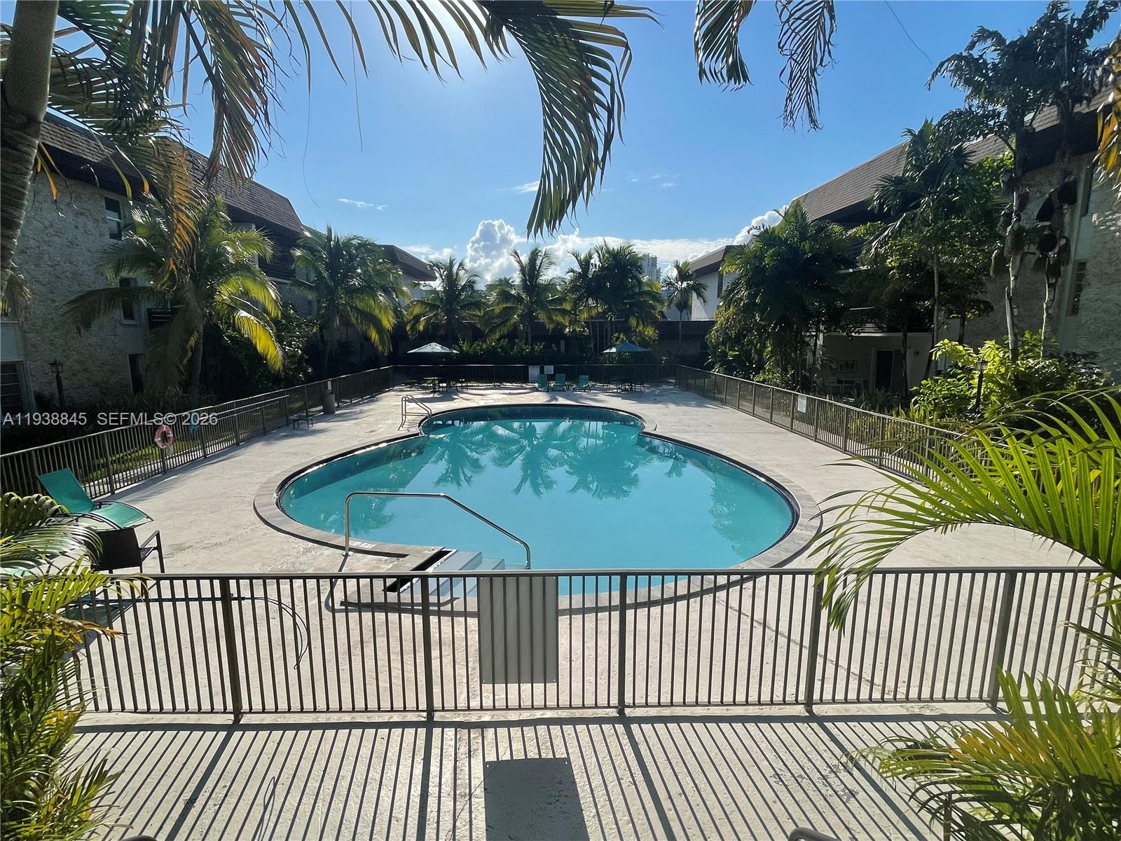 7483 Southwest 82nd Street, Unit A101 Miami, FL 33143 - Photo 4 of 39 a view of a swimming pool with a patio
