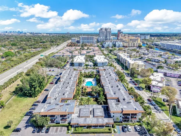 an aerial view of residential houses with city view