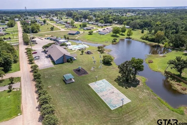 an aerial view of a house with garden space and lake view