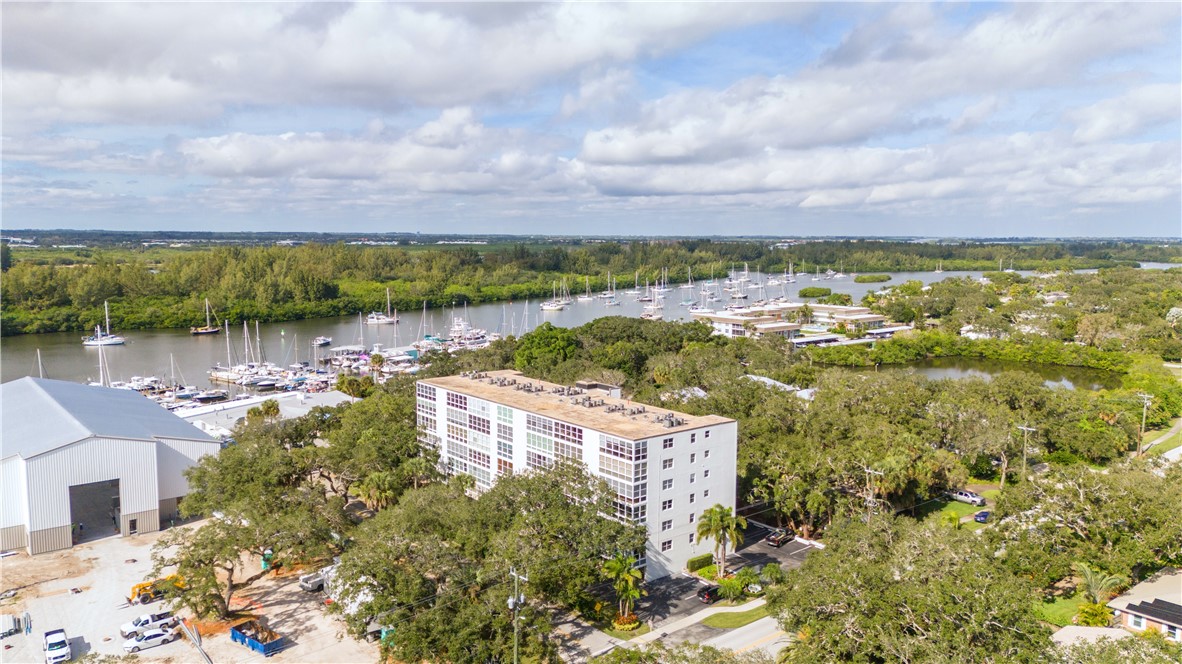 275 Date Palm Road, Unit 307 Vero Beach, FL 32963 - Photo 23 of 36 a view of a lake with houses in the back