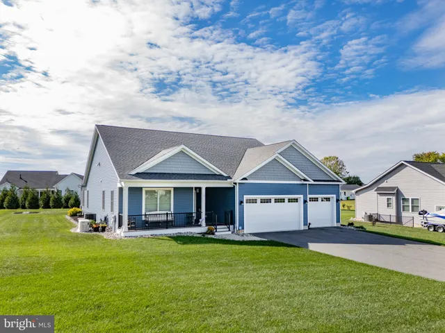 a view of a house with a big yard and large trees