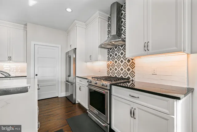 a kitchen with granite countertop a stove and a refrigerator