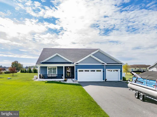 a view of a house with a garden and pathway