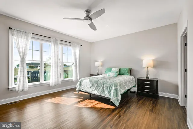 a bedroom with a large bed and a large window