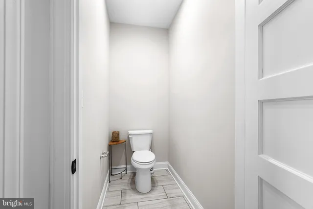 a white toilet sitting next to a white cabinet