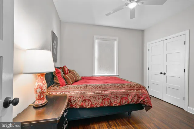 a bedroom with a bed and wooden floor