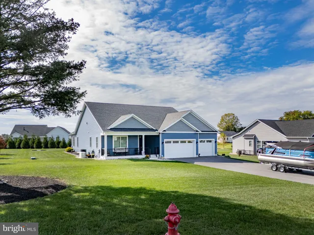 a view of house that has a big yard