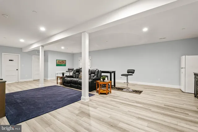 a living room with a gym equipment and a fireplace