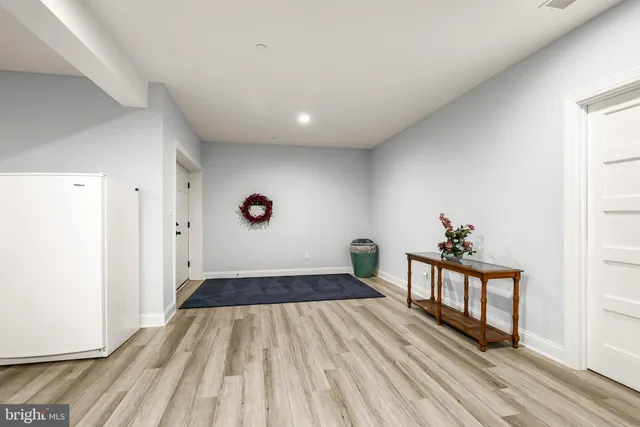 a view of a hallway view with wooden floor and staircase