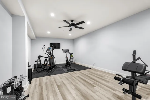 a room with gym equipment and view of living room