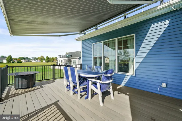 a view of a deck with table and chairs with wooden floor and fence