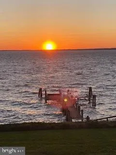 a view of a chairs and table on the green field