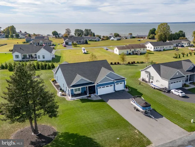 an aerial view of a house with a garden swimming pool and outdoor seating