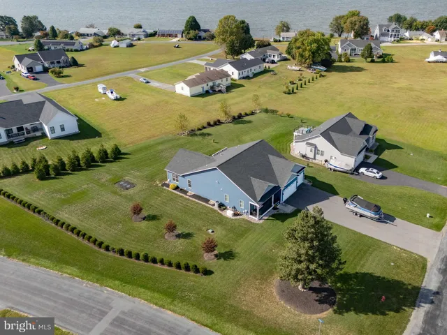 an aerial view of a house with a swimming pool yard and lake view