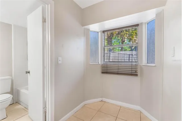 a bathroom with a toilet a sink and a window