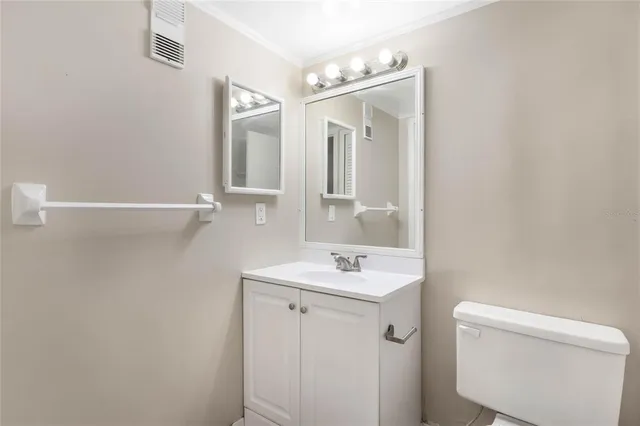 a bathroom with a sink a toilet and mirror