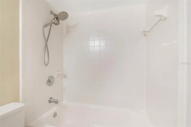 a bathroom with a bath tub with a shower