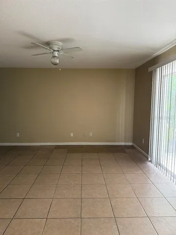 an empty room with a empty space and windows