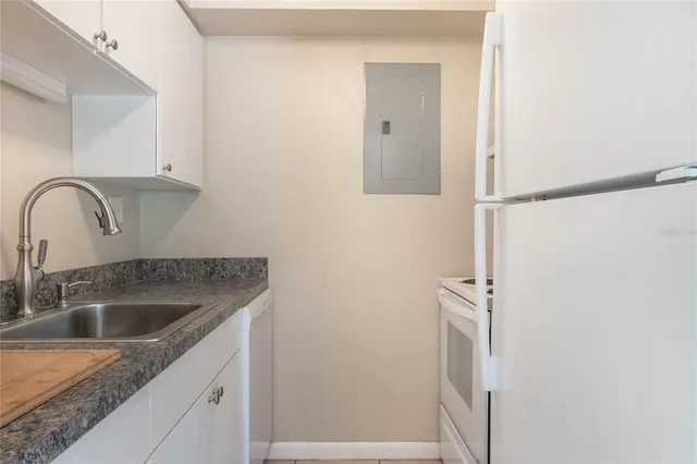 a close view of a sink a faucet and appliance in the kitchen