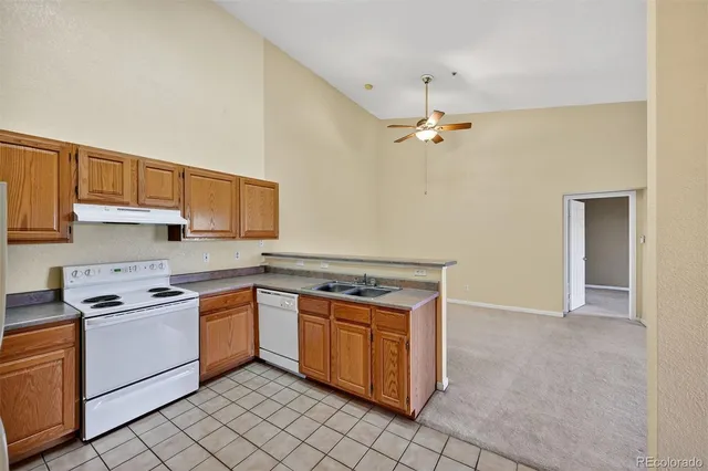 a kitchen with a stove sink and cabinets