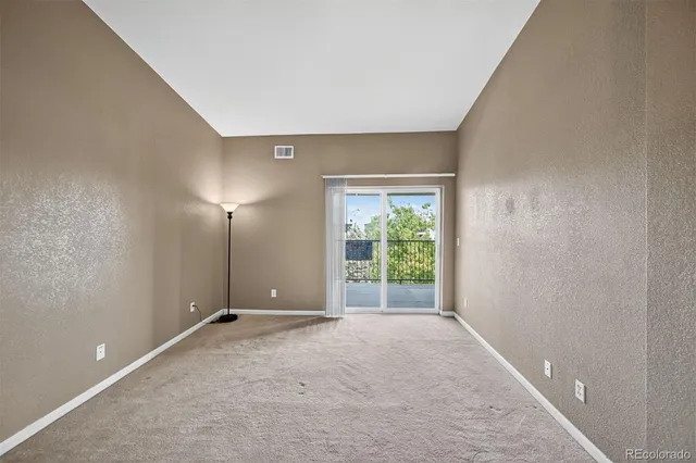 an empty room with windows and yard