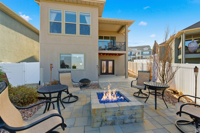 987 East Deer Arch Lane Draper, UT 84020 - Photo 42 of 46 Back patio / terrace featuring french doors, a fenced backyard, and gas fire pit