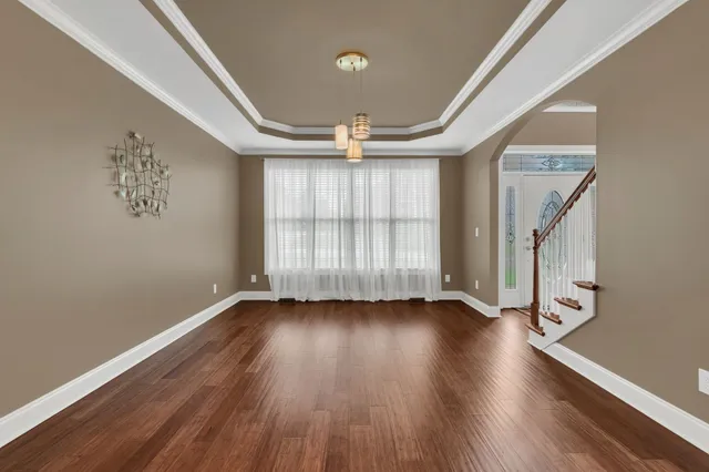 wooden floor in an empty room with a window