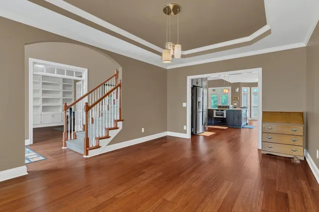 a kitchen with stainless steel appliances a refrigerator sink and wooden cabinets