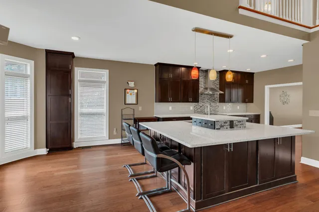 a view of a big room with wooden floor and windows
