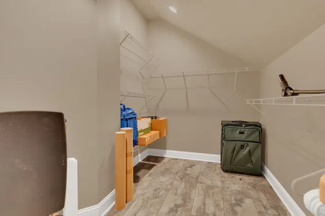 an empty room with chandelier fan