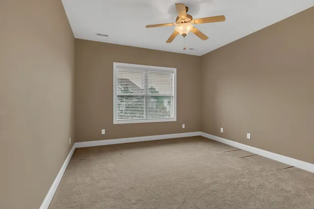 a bathroom with a granite countertop sink and a large mirror