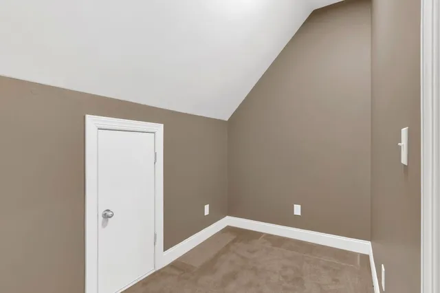 a front view of a house with a garden and plants