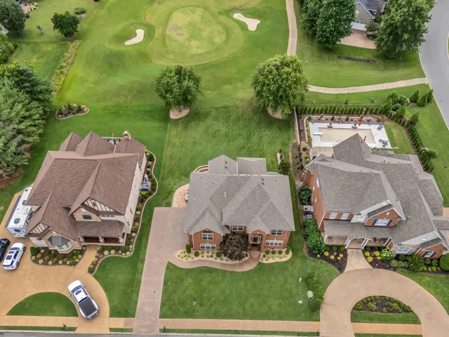 an aerial view of a house with outdoor space patio and trees all around