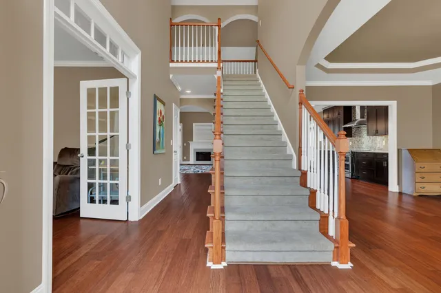 a view of an entryway with wooden floor and front door