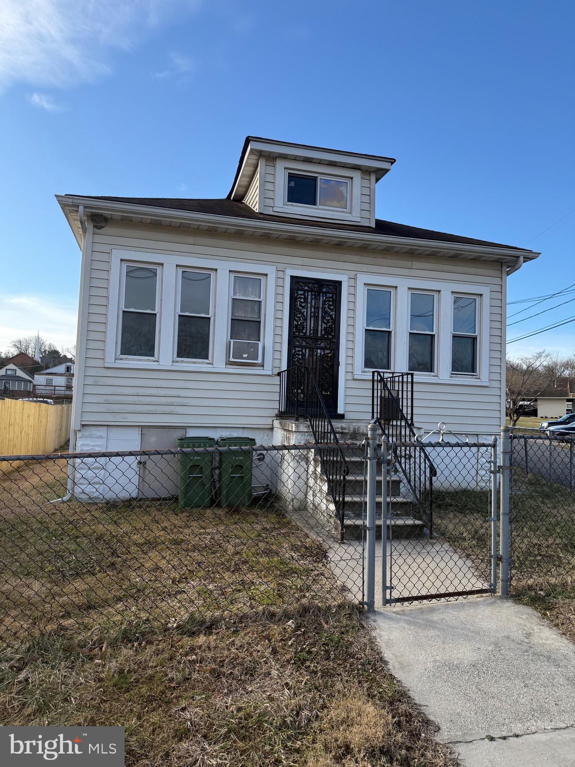 239 Midland Brooklyn, MD 21225 - Photo 13 of 13 a front view of a house with garden