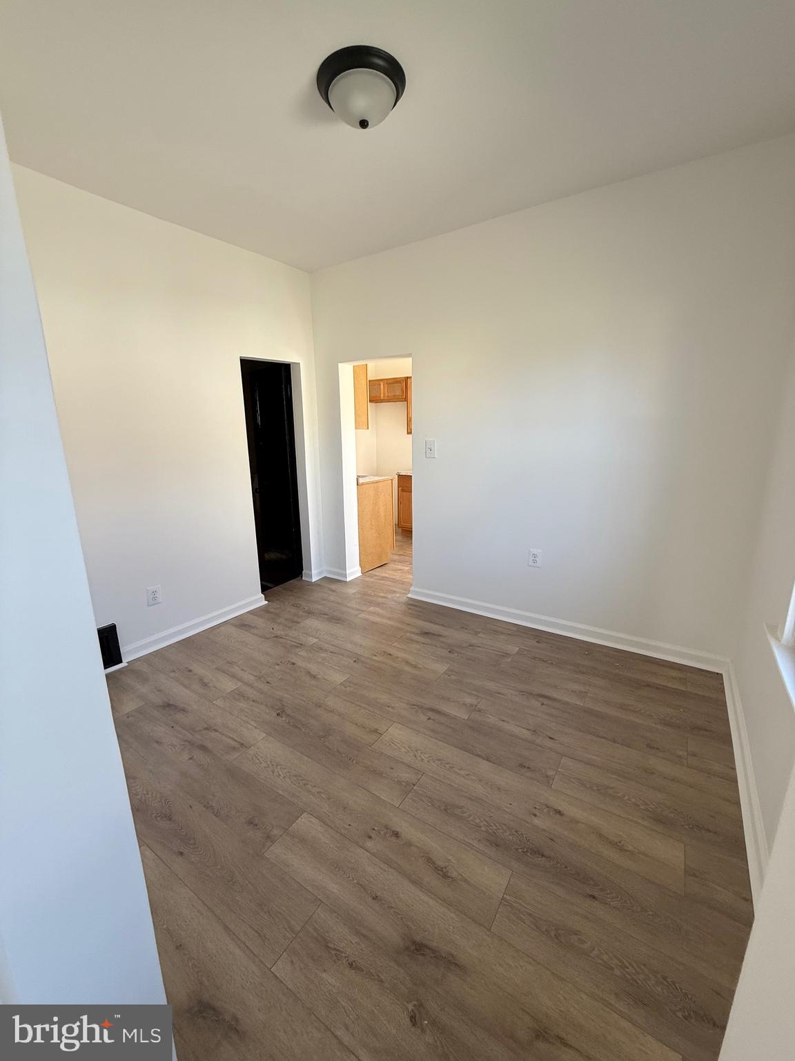 239 Midland Brooklyn, MD 21225 - Photo 4 of 13 a view of a room with wooden floor and window