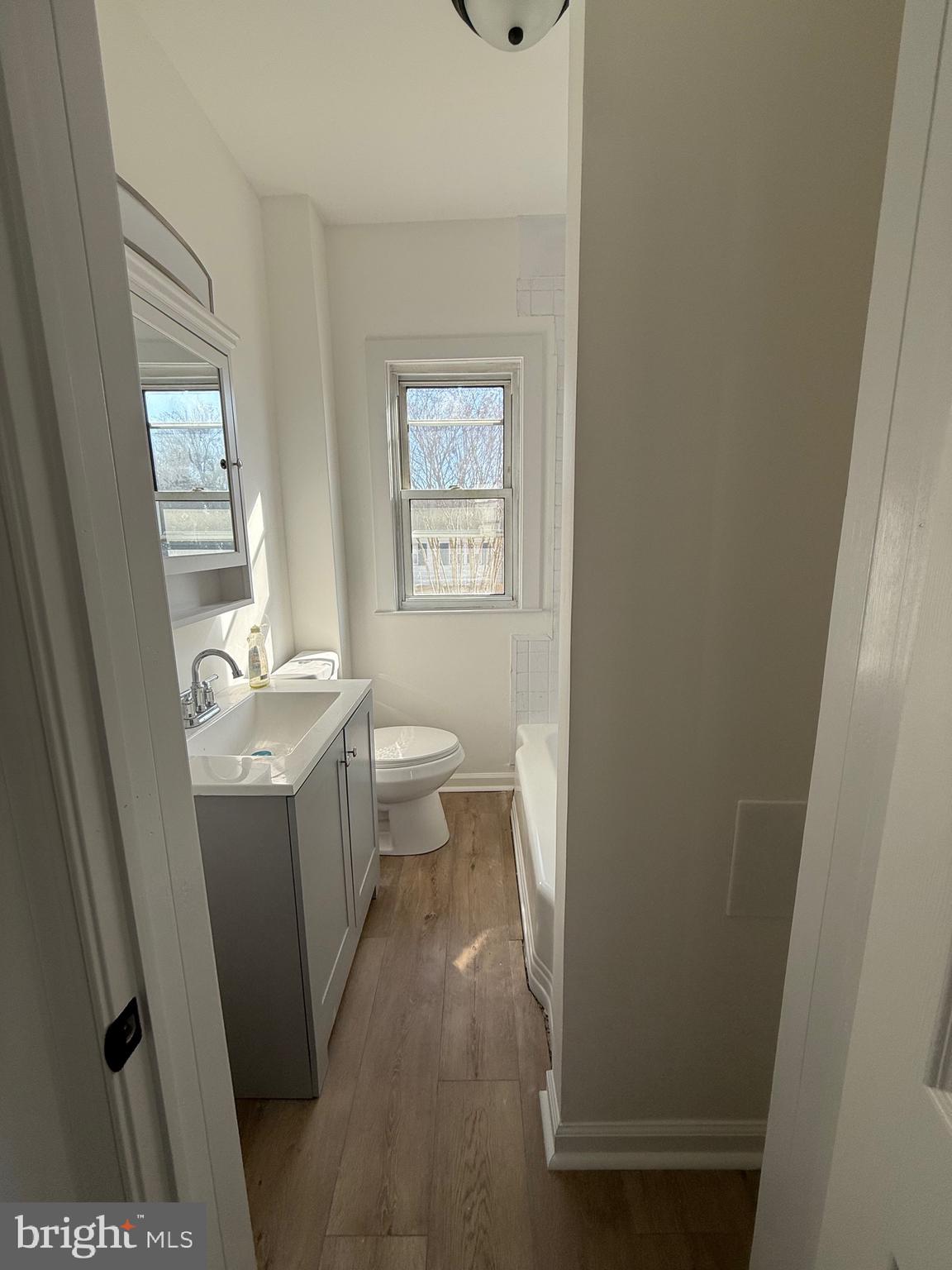 239 Midland Brooklyn, MD 21225 - Photo 7 of 13 a bathroom with a sink a toilet and a mirror
